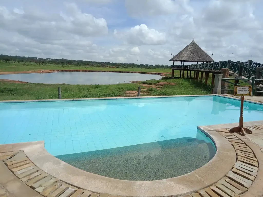 Guest rooms overlooking a waterhole at Voi Wildlife Lodge in Tsavo East National Park